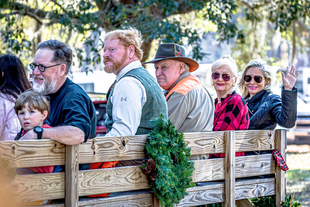 Adults and children seated together on the Tally-Ho Wagon.