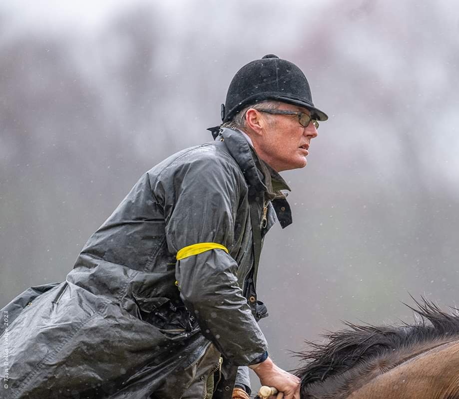 David Gray Raley riding in a grey raincoat