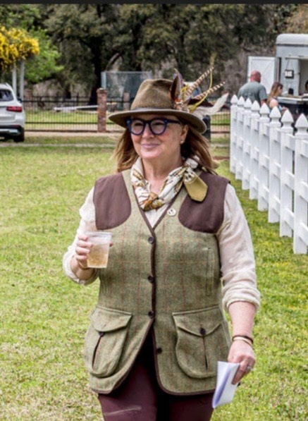 Lindy Birch Kelly outdoors in a feathered hat