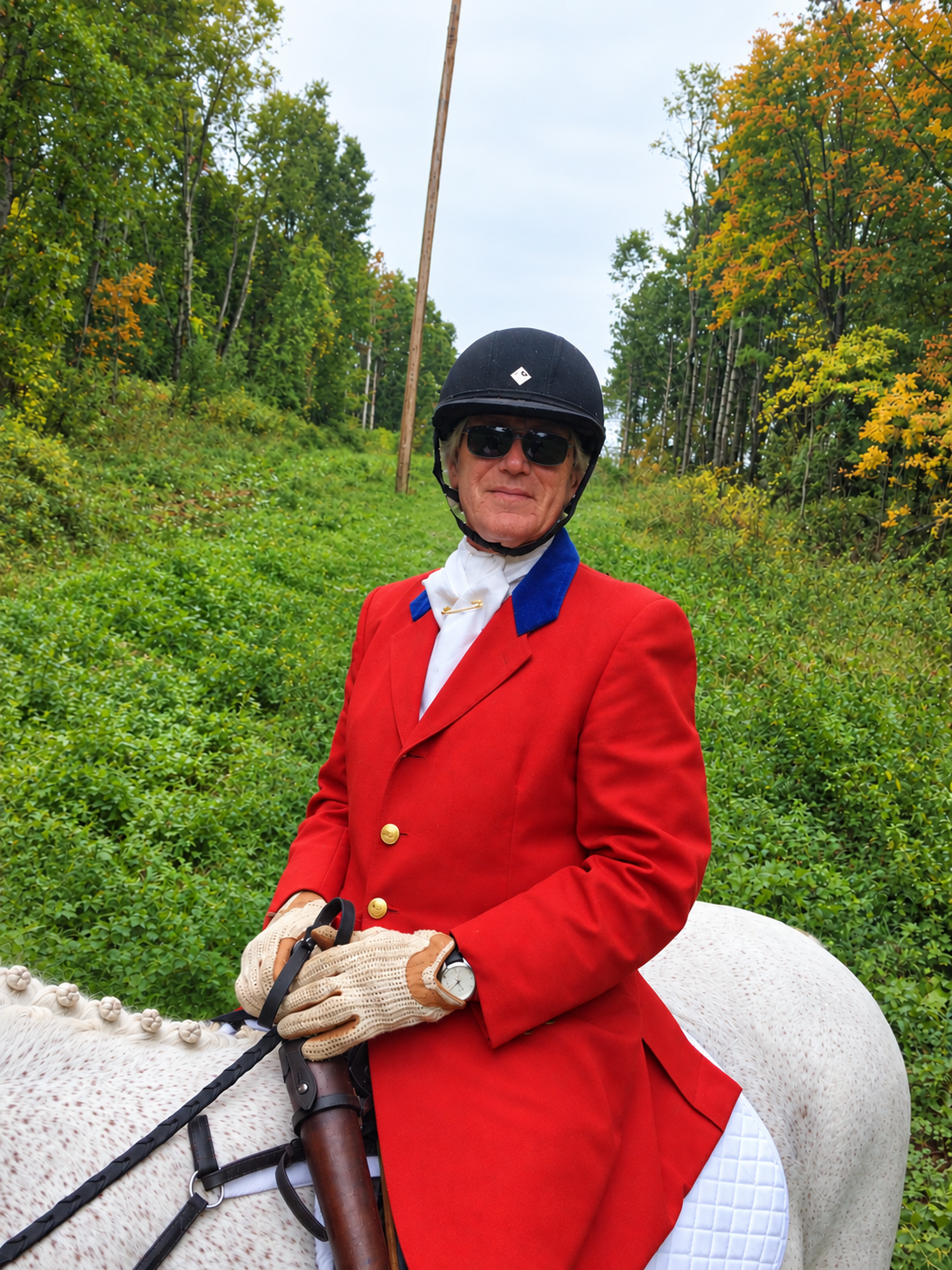 Dr. Casey Bartman mounted on Malachi in a wooded lane