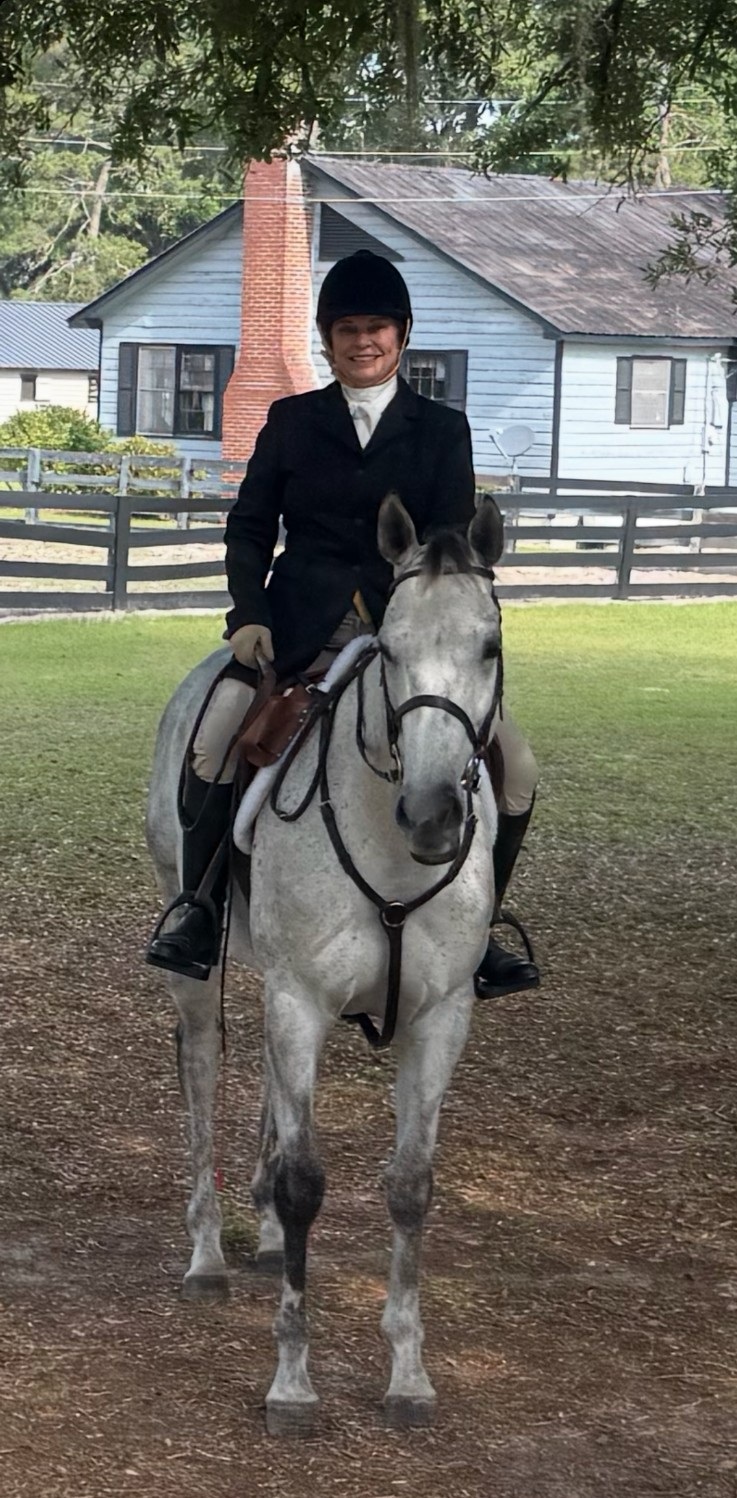 Mary Foster mounted on a grey horse