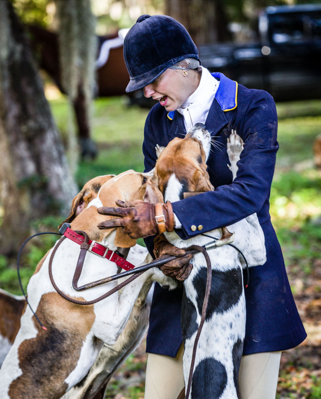 Elizabeth Howard in hunt attire holding a hound